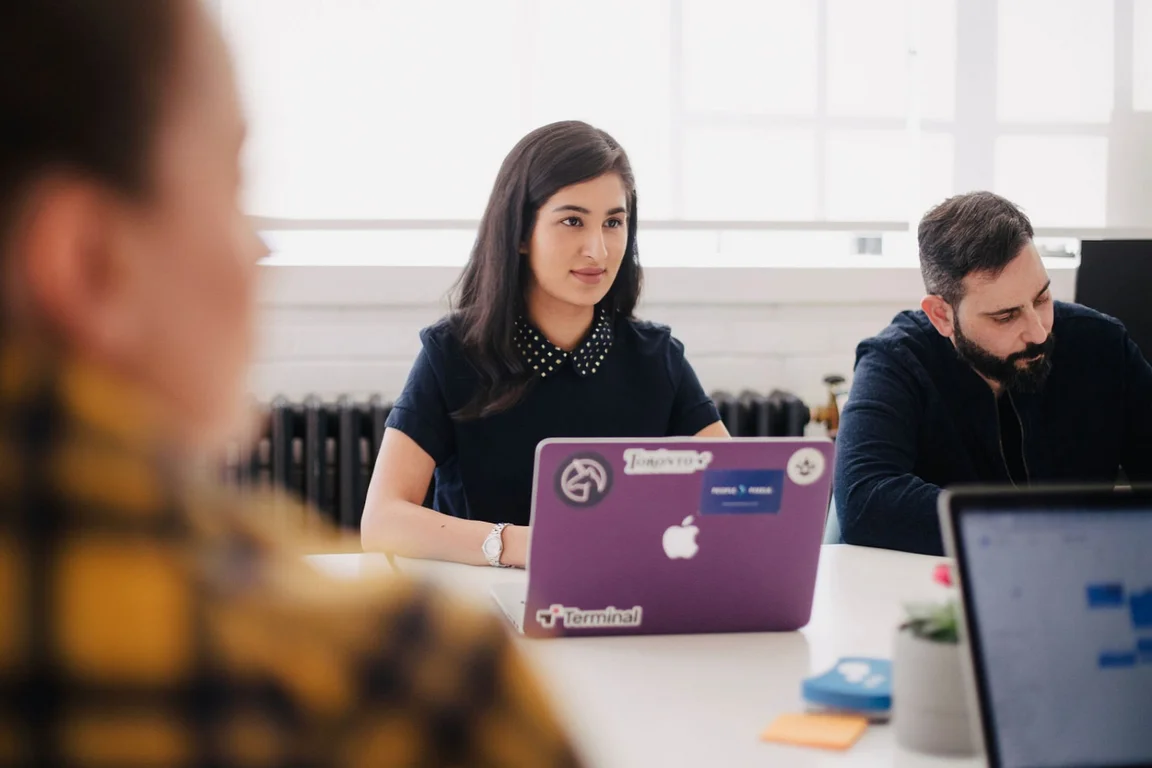 a micro event with people sat around a desk