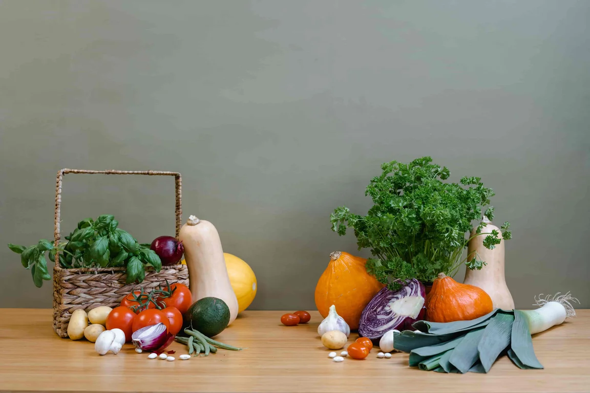 a table with various fruit and vegetables