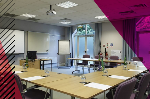 Board meeting room at Woodland Grange, tables and chairs positioned in a U-shape formation.