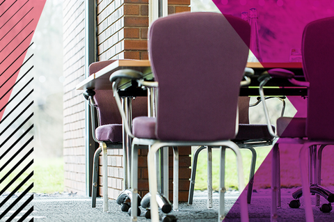 Table and chairs shown from a downwards angle in a Woodland Grange training room.