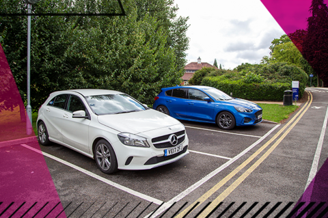 Woodland Grange car parking facilities, with a white Mercedes and blue Ford reverse parked in two spaces.