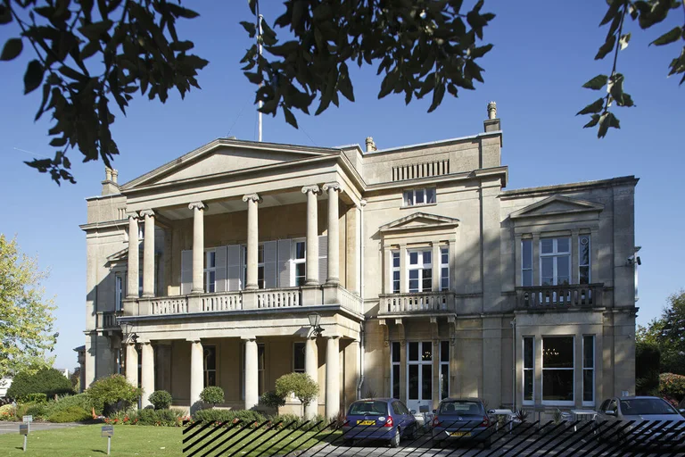 The exterior of engineers' House, showing the car parking facilities and garden,