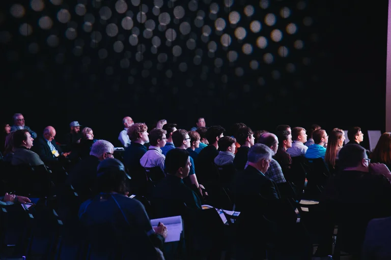 People seated at conference event 