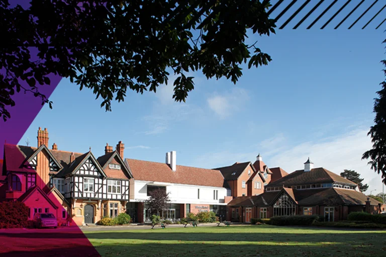 Corporate events venue Woodland Grange with green space in the foreground.